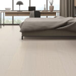 Wooden bedroom interior with bed on carpet, window and workplace